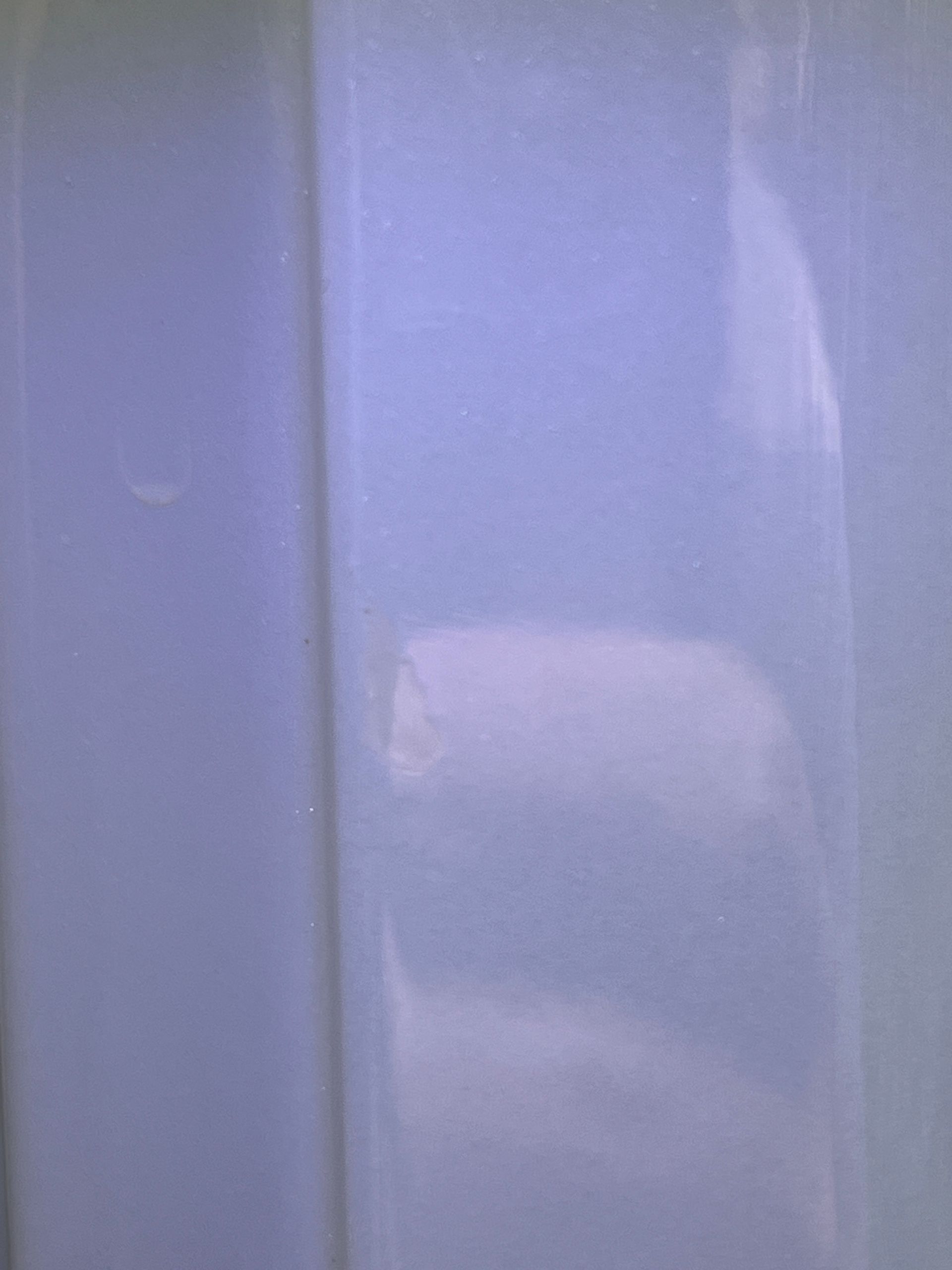 Light blue vertical surface with a white, rectangular patch.