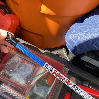 A person holds a blue 