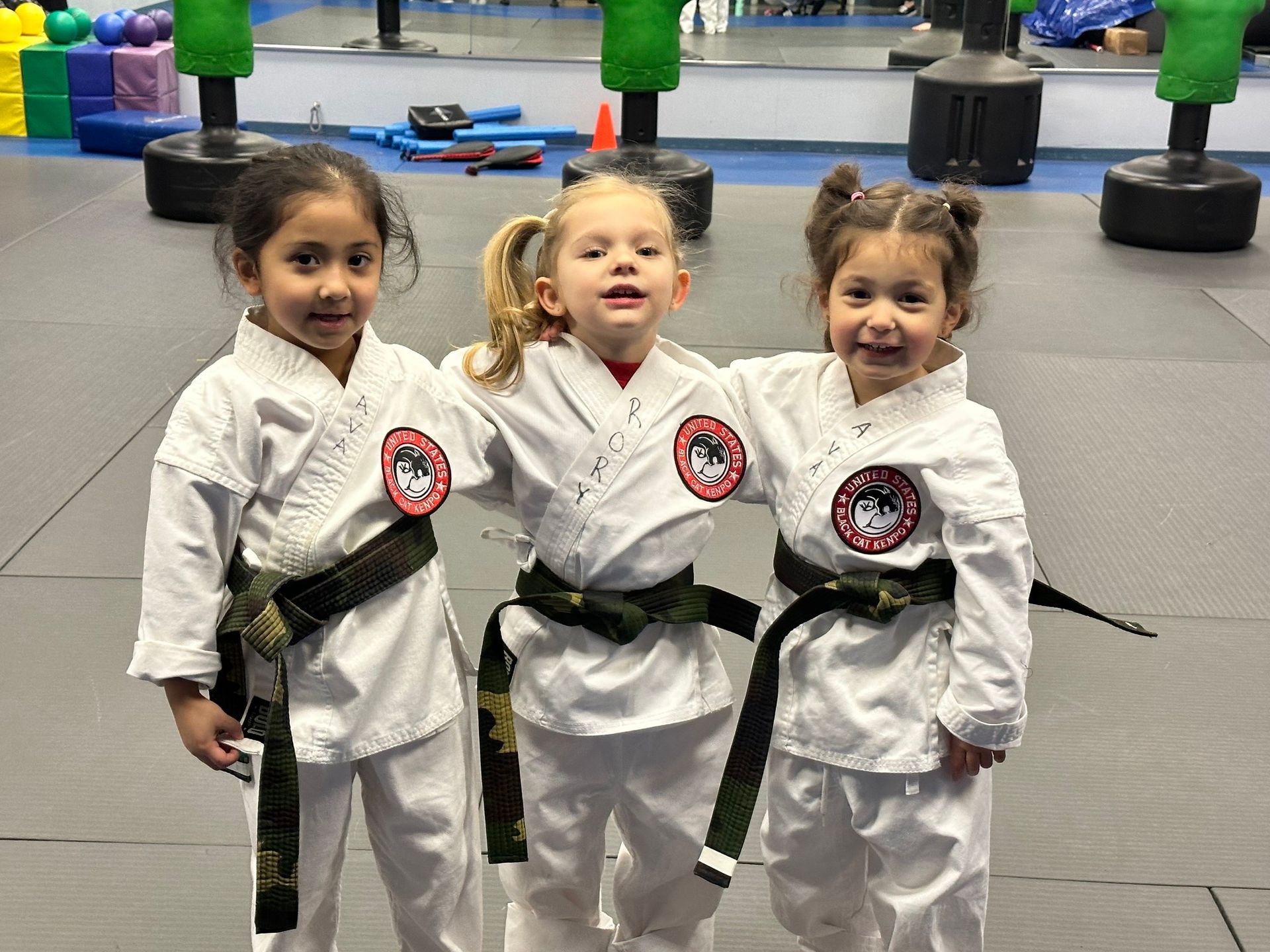 two young boys wearing white karate uniforms with yellow belts