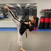 a young boy wearing a black shirt that says believe in yourself
