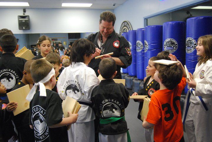 a group of young boys are practicing karate in a gym