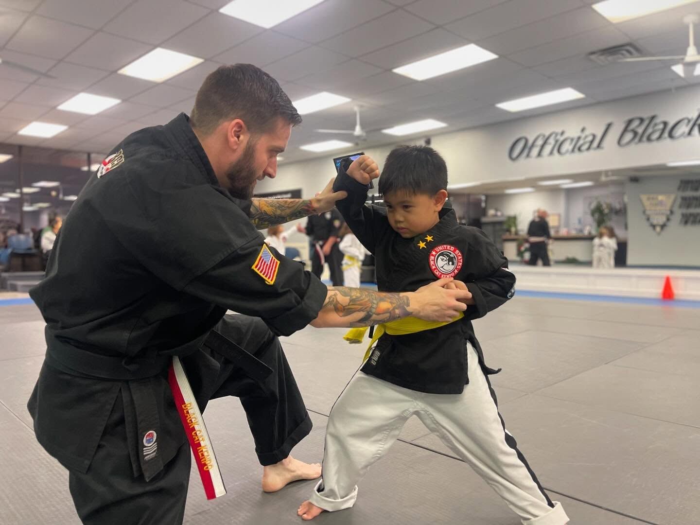a group of kids are posing for a picture at east west karate