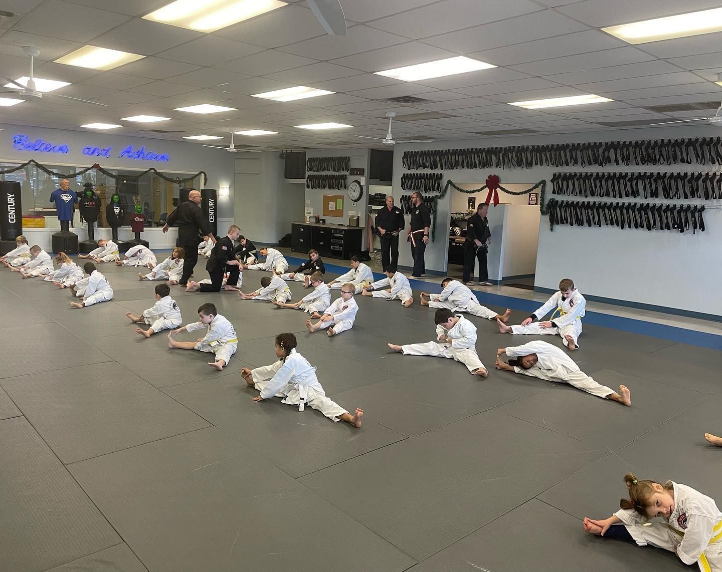 a group of kids are posing for a picture at east west karate