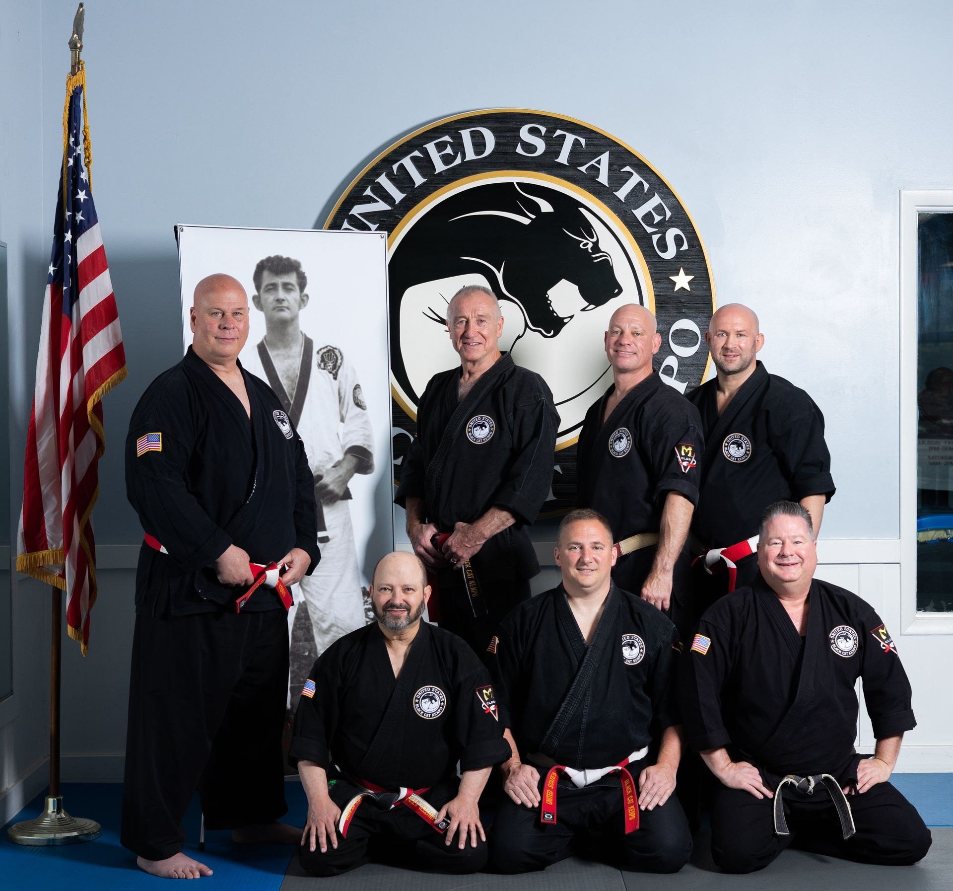 A man in a white karate uniform with a black belt