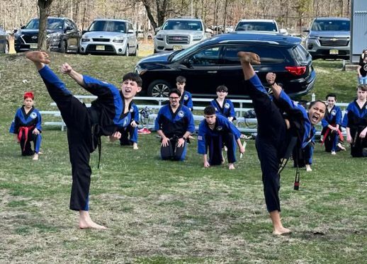 A group of men are posing for a picture and one of them has a triangle on his shirt