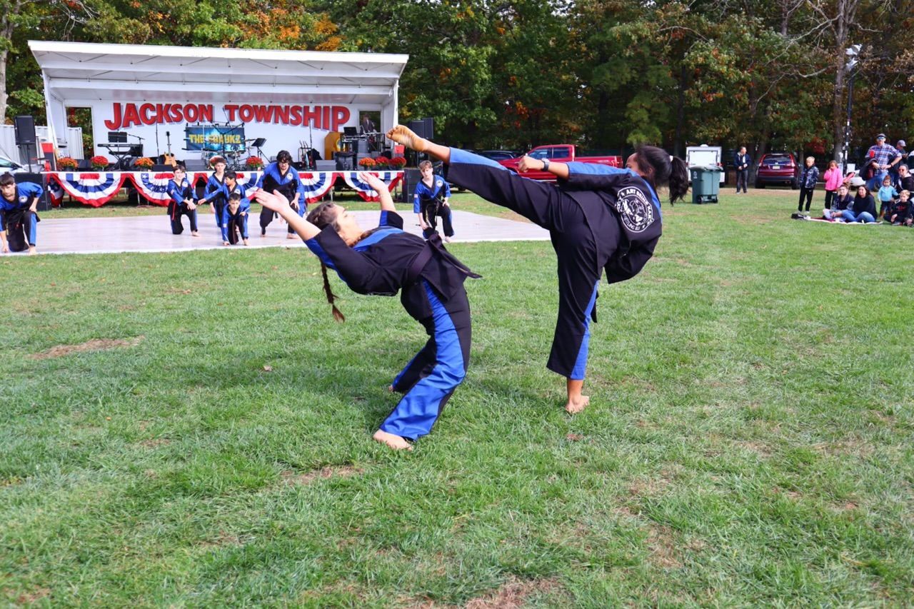 A black and white photo of a group of people in karate uniforms