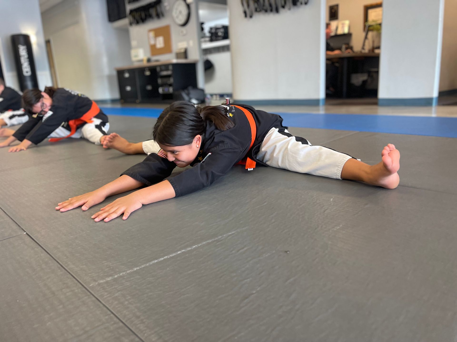 a group of kids are posing for a picture at east west karate
