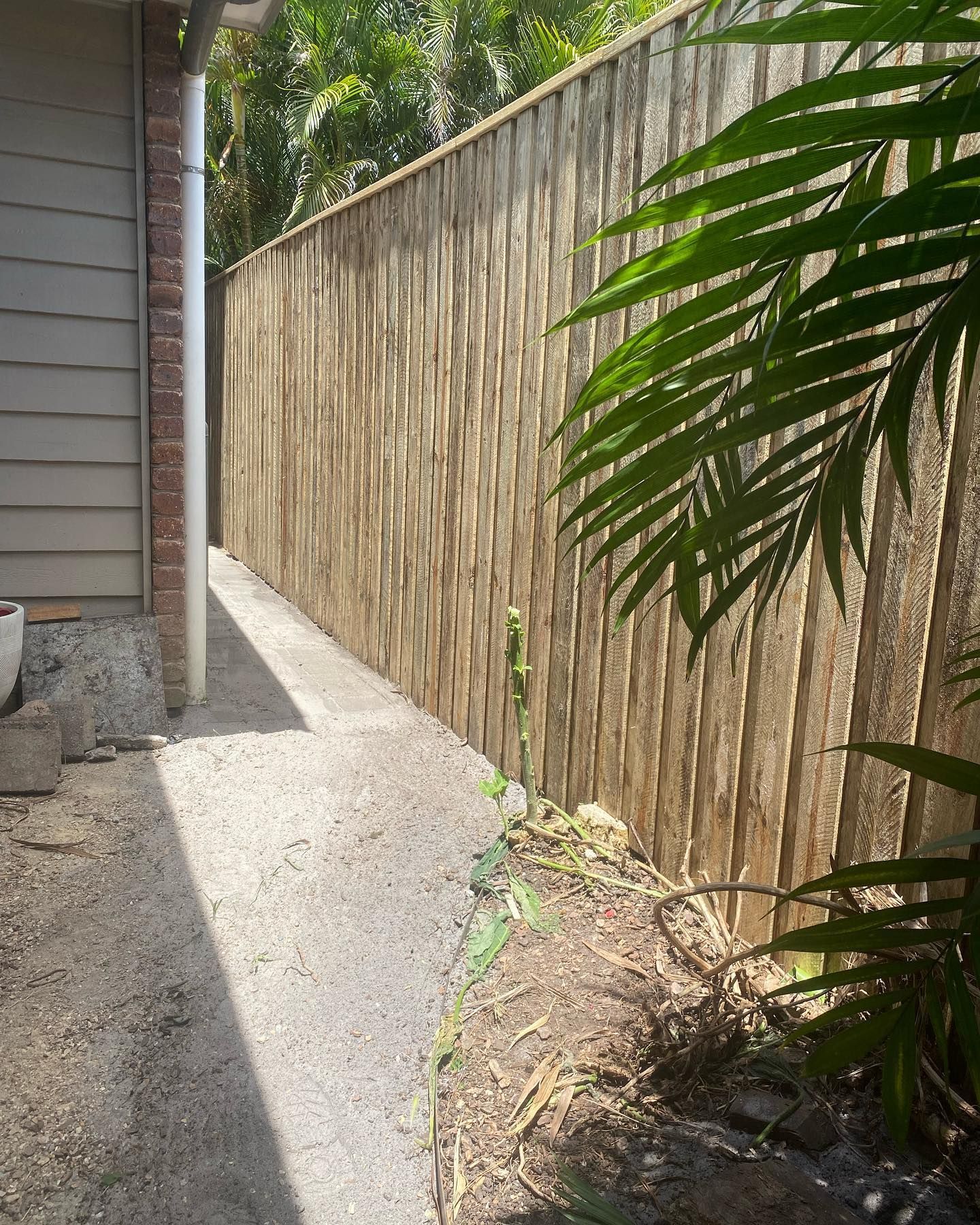 A Wooden Fence Along a Sidewalk Next to a House — Fence & Deck Australia Pty Ltd in Kingscliff, NSW