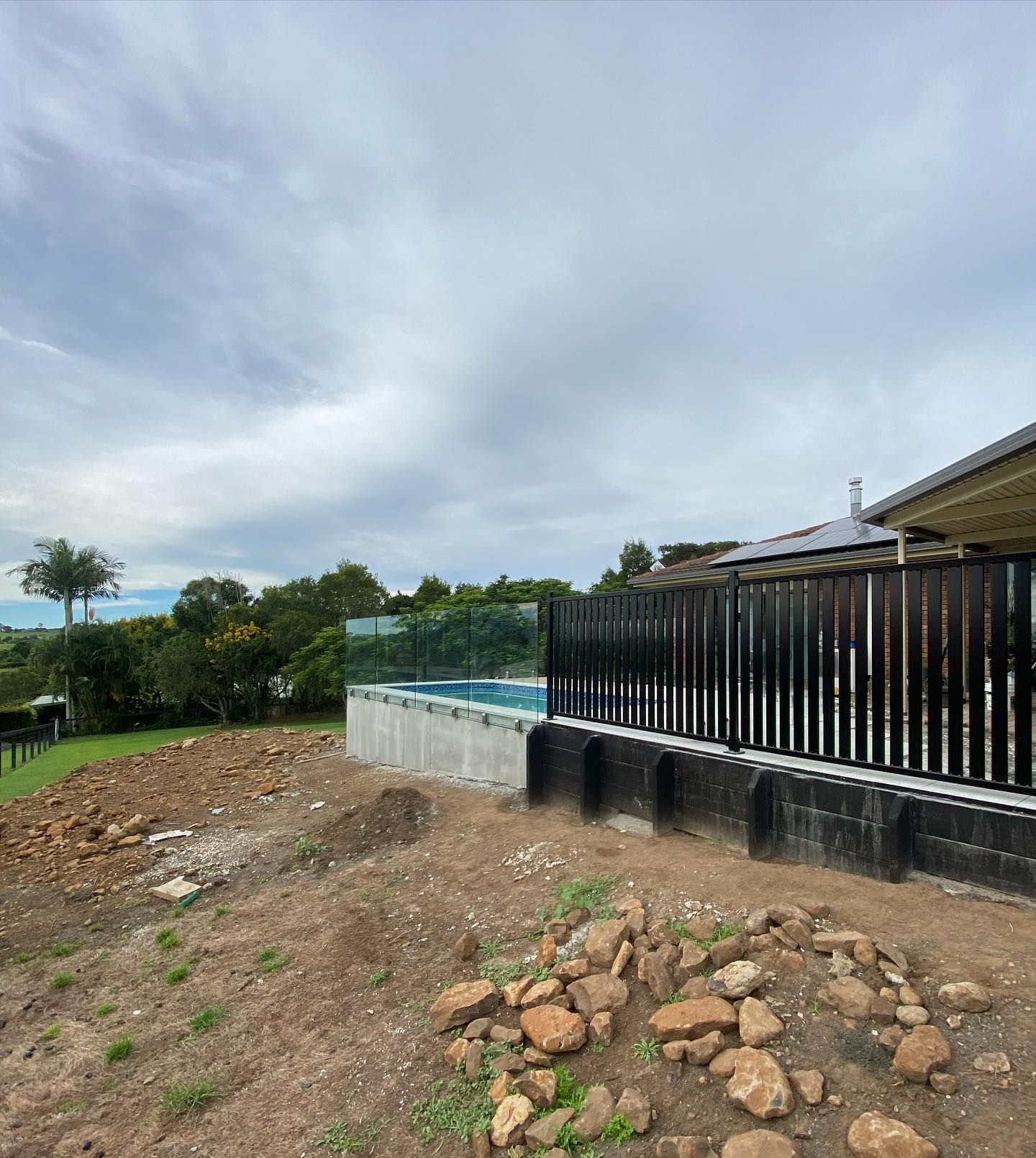 A House With a Fence Around It and a Pool in the Backyard — Fence & Deck Australia Pty Ltd in Balina, NSW