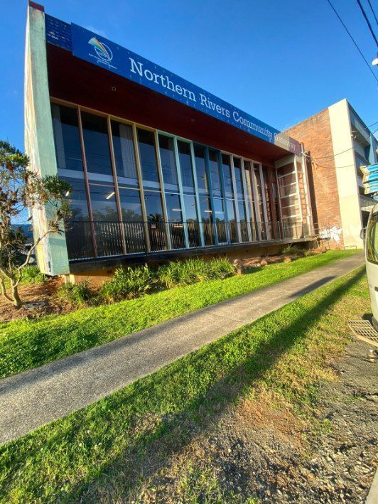 A Large Building With a Fence and a Sign That Says Northern Rivers Community — Fence & Deck Australia Pty Ltd in Casino, NSW