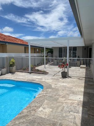 There is a Swimming Pool in the Backyard of a House — Fence & Deck Australia Pty Ltd in Kingscliff, NSW