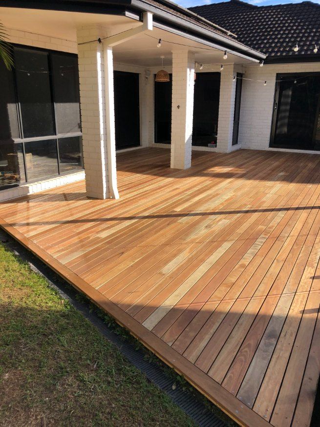 A Large Wooden Deck is in Front of a House — Fence & Deck Australia Pty Ltd in Casino, NSW