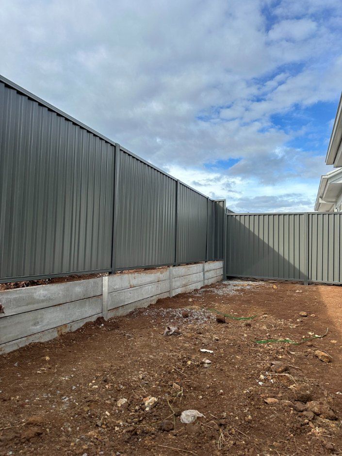 A Fence is Being Built in the Backyard of a House — Fence & Deck Australia Pty Ltd in Casino, NSW