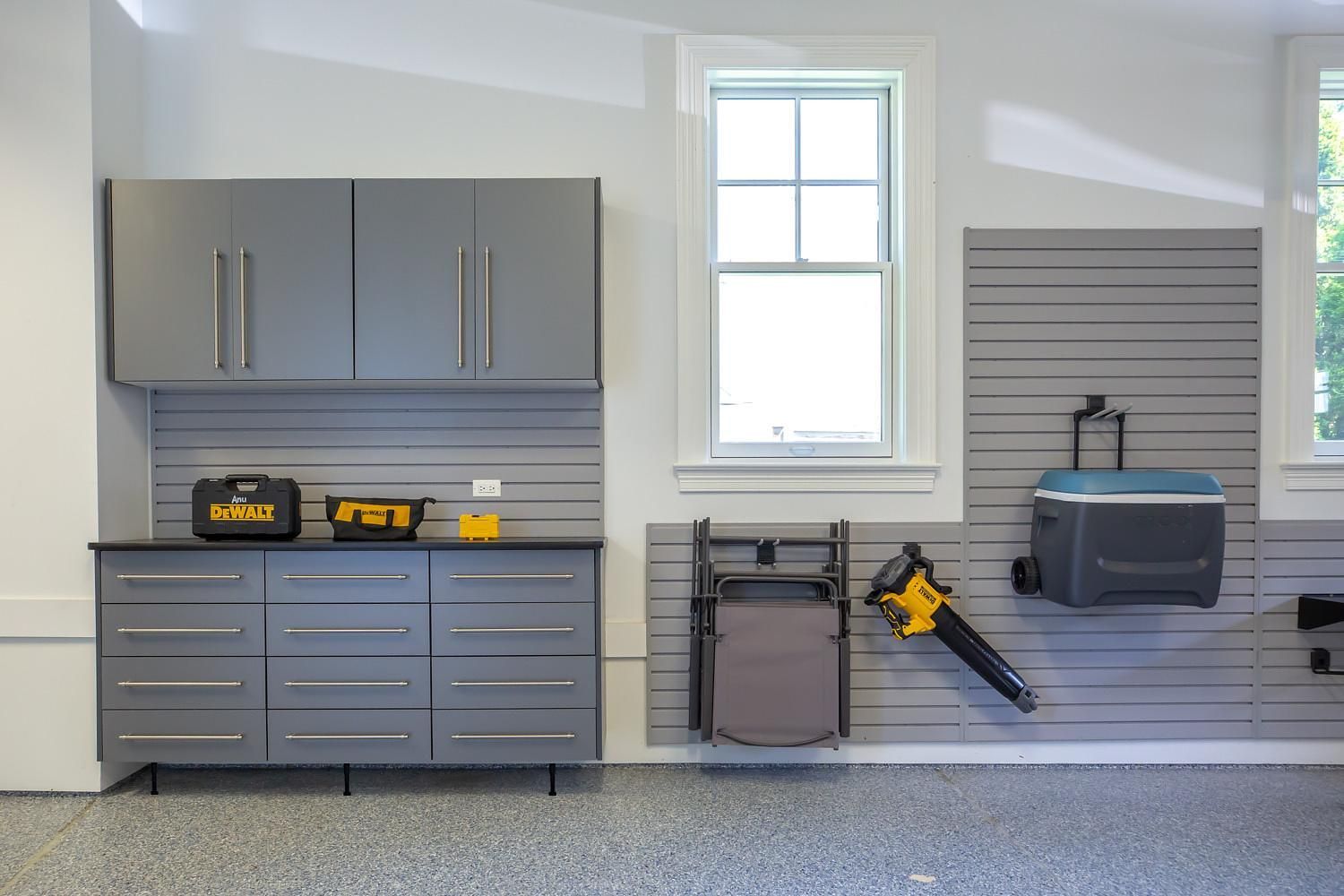 A garage with gray cabinets and a window.