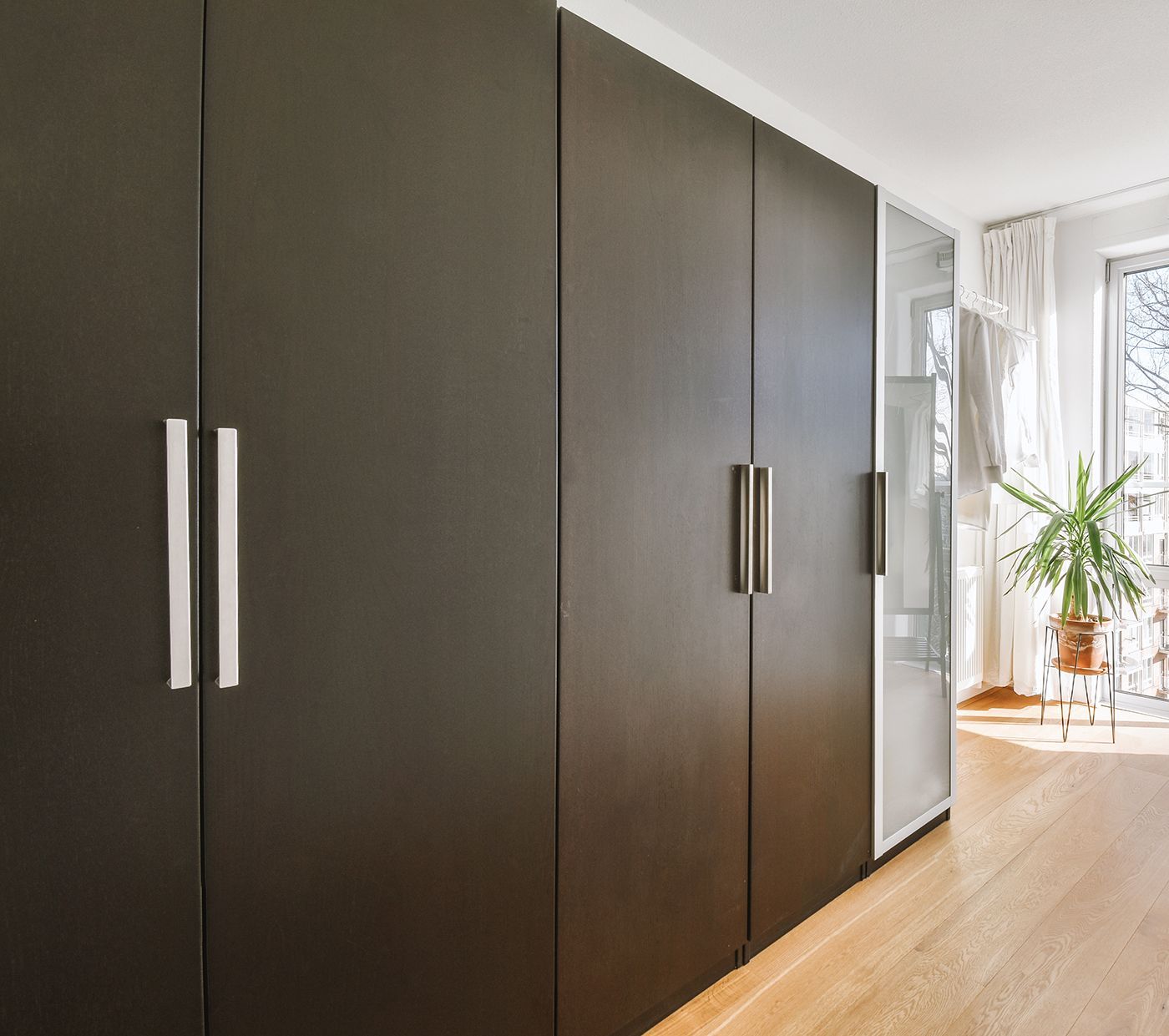 A walk in closet with lots of shelves and drawers