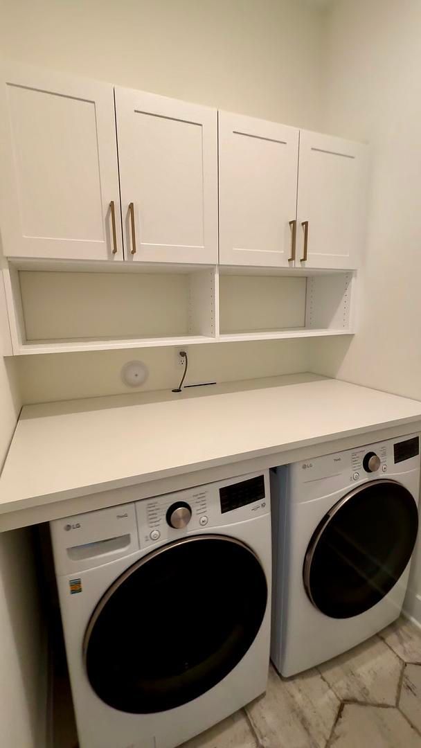 A laundry room with a washer and dryer on a counter.