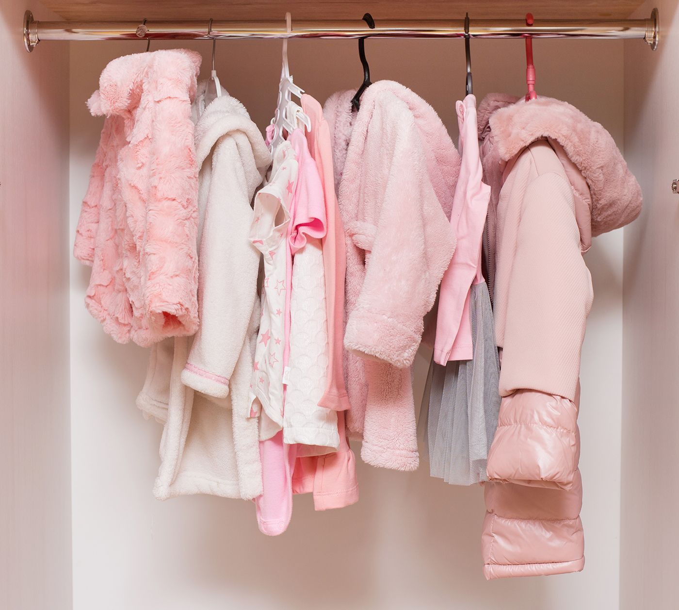 A walk in closet with lots of shelves and drawers