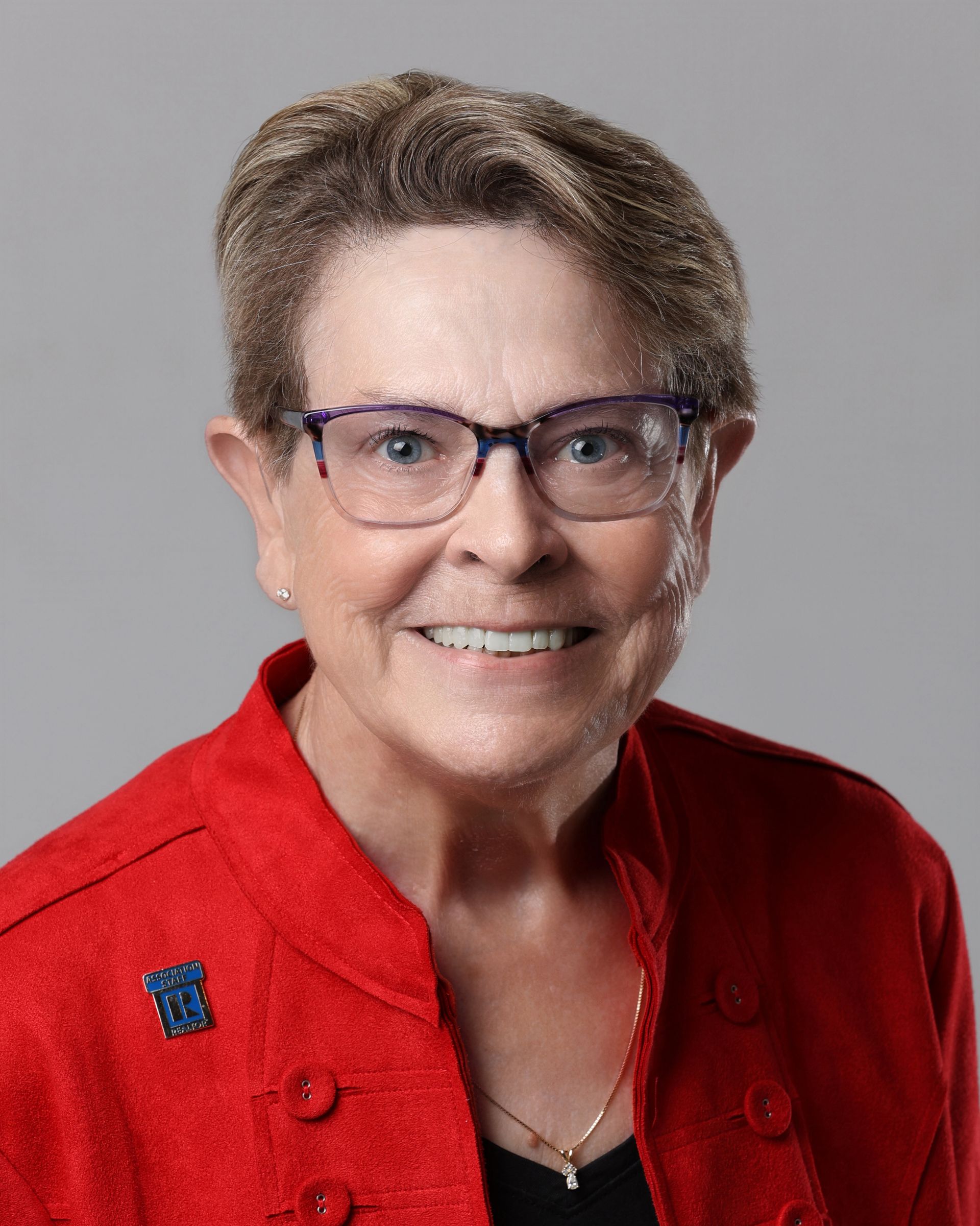A man is sitting at a desk in an office holding a folder.