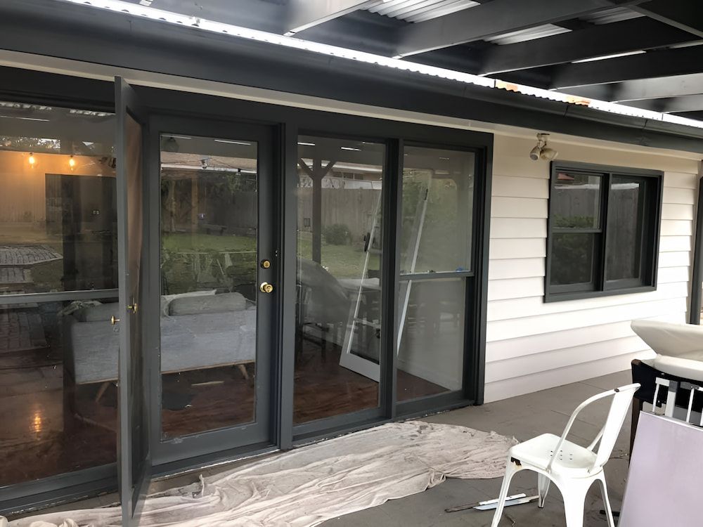 A House With A Lot Of Windows And Sliding Glass Doors — L & S Wirth Painting in Dubbo, NSW