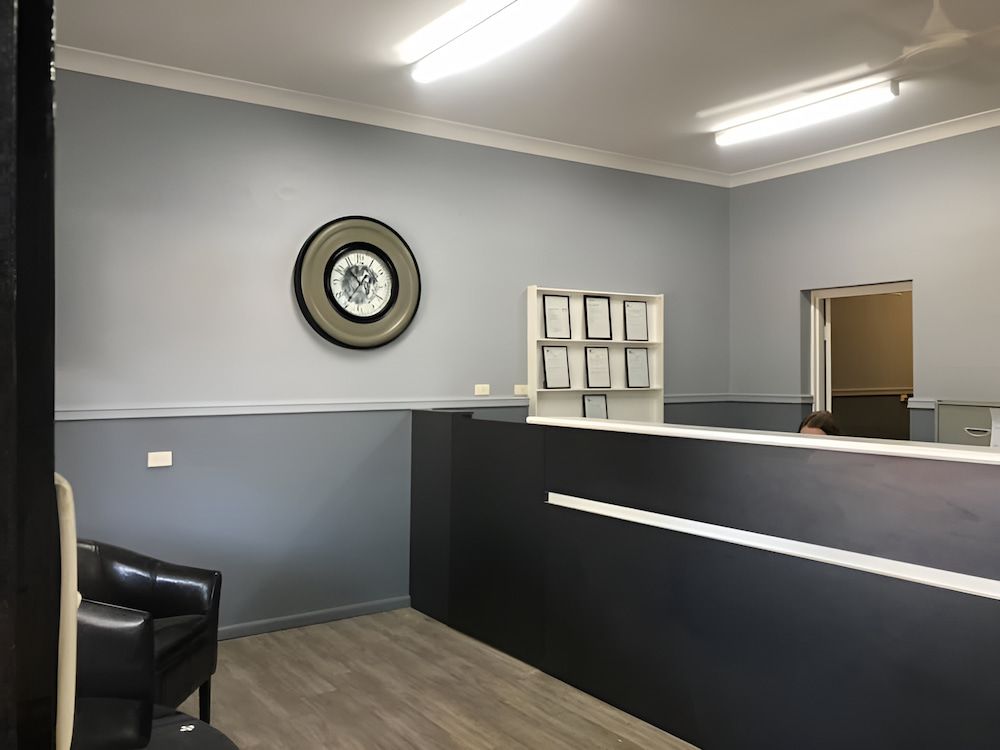 A Waiting Room With A Black Chair And A Clock On The Wall — L & S Wirth Painting in Dubbo, NSW