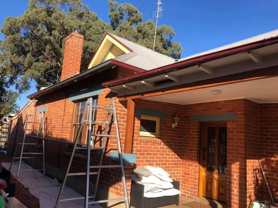 A Ladder Is Sitting On The Side Of A Brick House — L & S Wirth Painting in Wellington, NSW