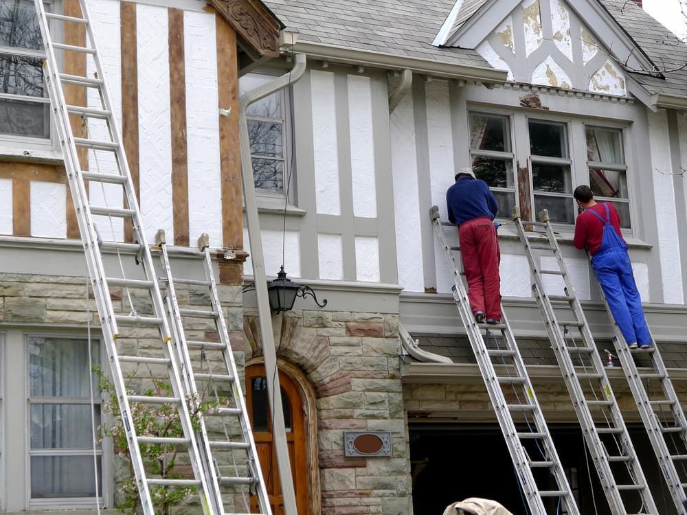 Two Men On Ladders Paint The Side Of A House — L & S Wirth Painting in Gilgandra, NSW