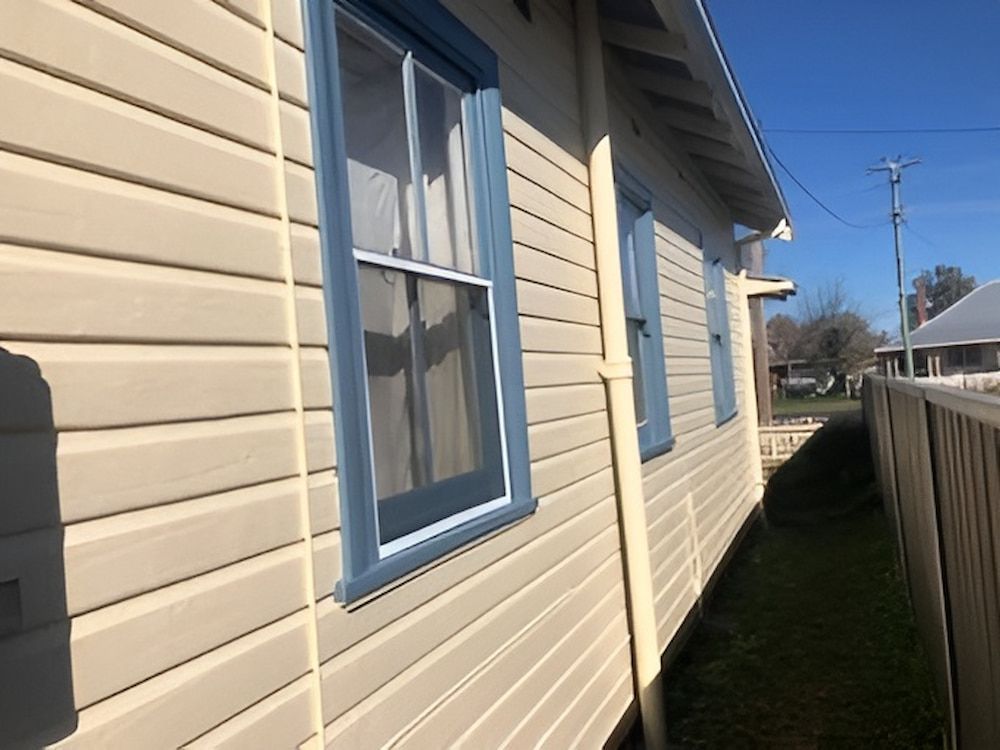 The Side Of A House With A Fence And A Lot Of Windows — L & S Wirth Painting in Dubbo, NSW