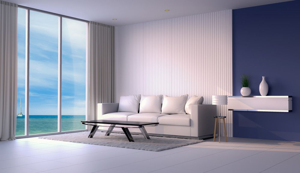 A Living Room With A Couch, Table, And Large Windows — L & S Wirth Painting in Coonamble, NSW