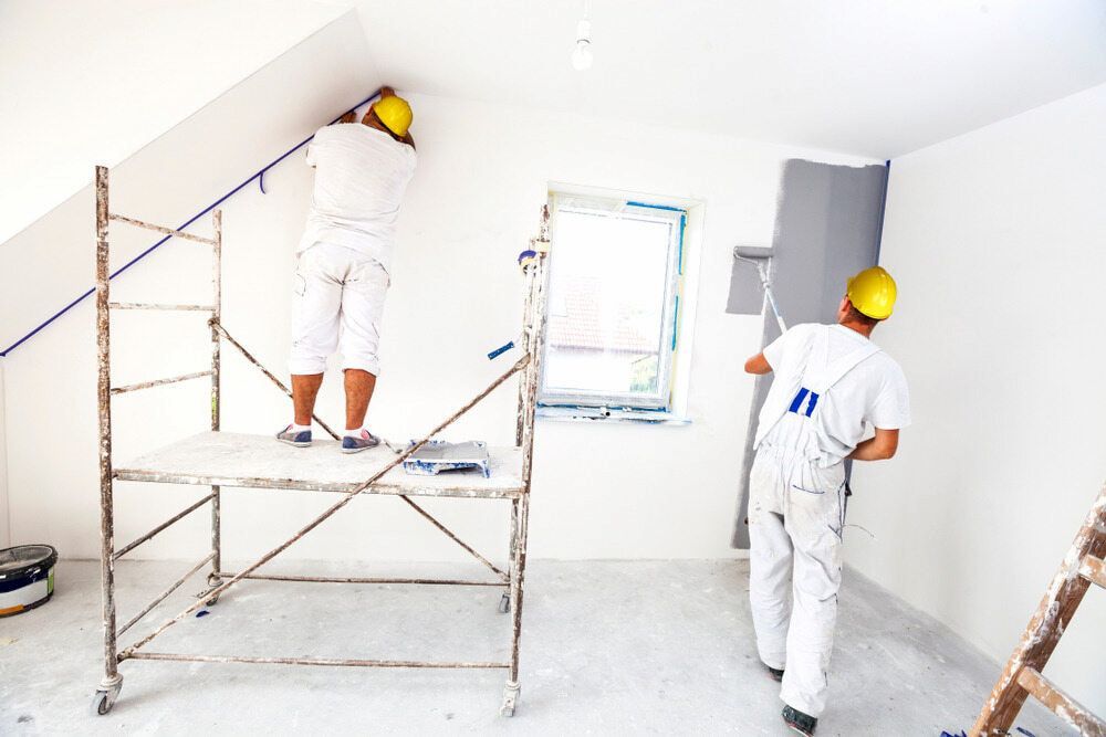 Two Men Are Painting A Wall In A Room — L & S Wirth Painting in Nyngan, NSW