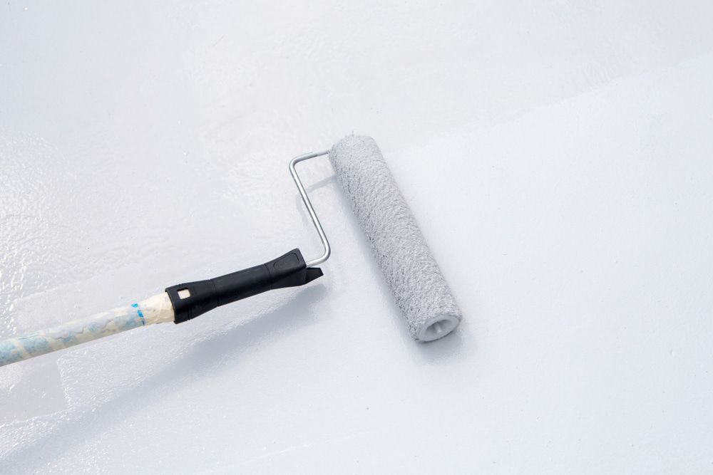 A Paint Roller Is Being Used To Paint A White Wall — L & S Wirth Painting in Wellington, NSW