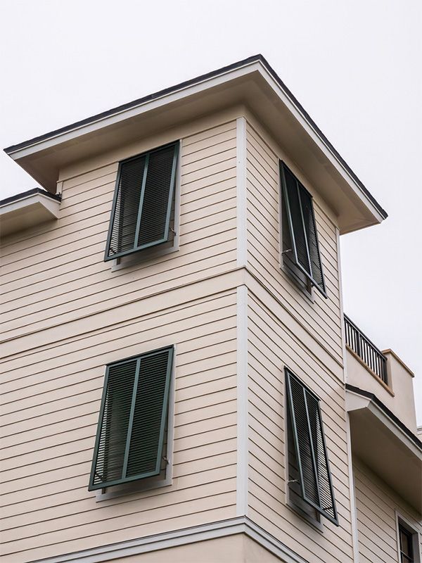 Dining area with white zebra blinds, table, chairs, and a pendant light fixture.