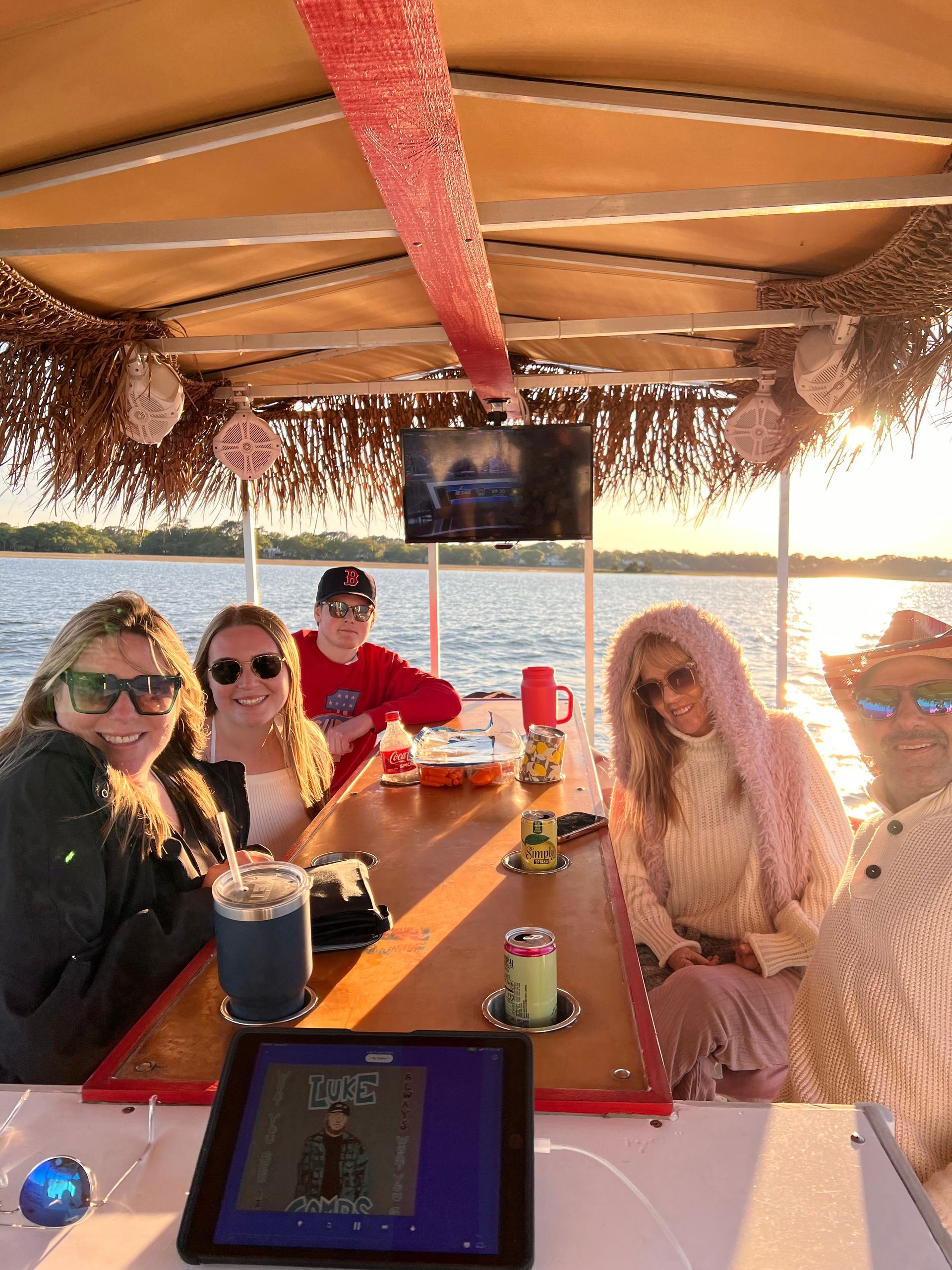 A group of people are sitting at a table on a boat.