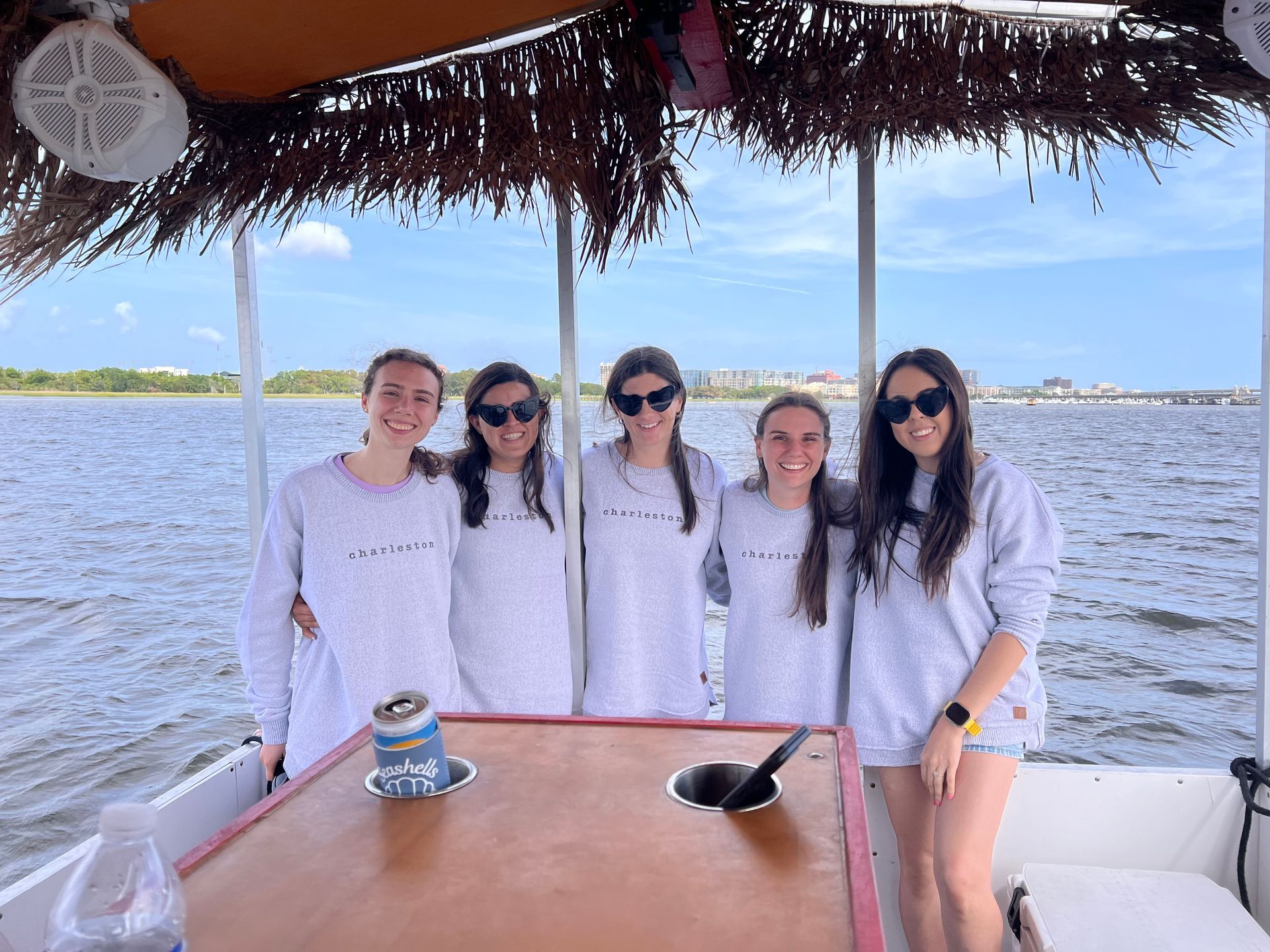 A group of women are posing for a picture on a boat.