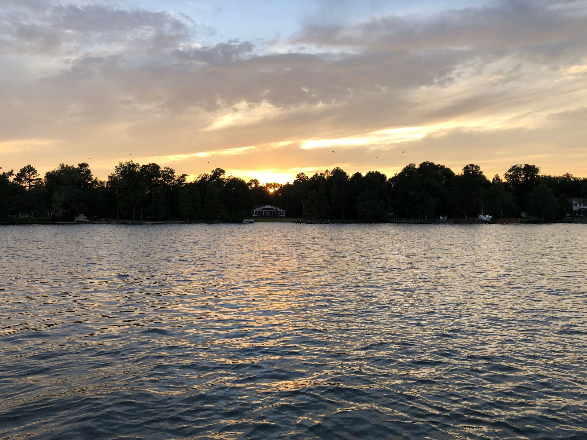 A large body of water with a sunset in the background