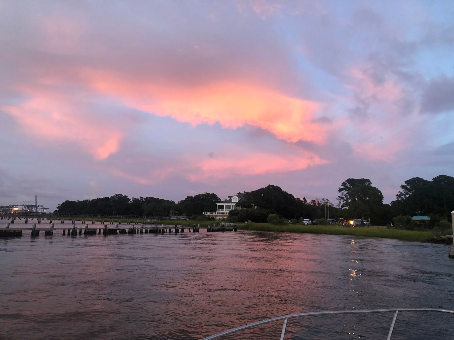 A sunset over a body of water with trees in the background