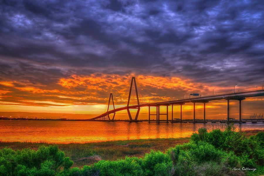 A bridge over a body of water at sunset.