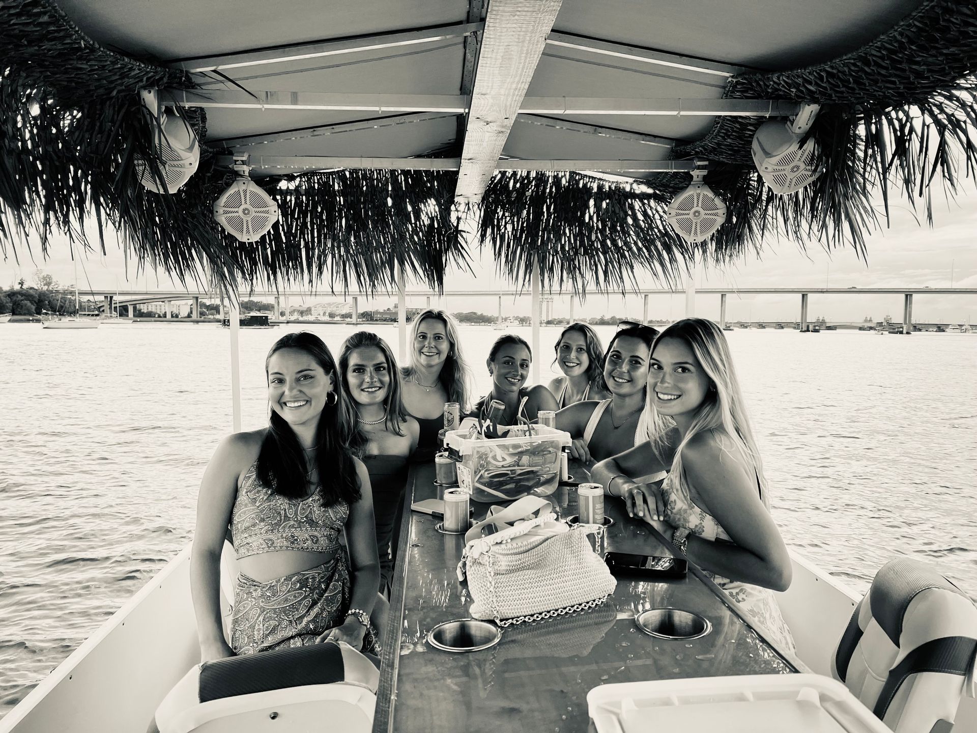 A group of women are sitting on a boat in the water.