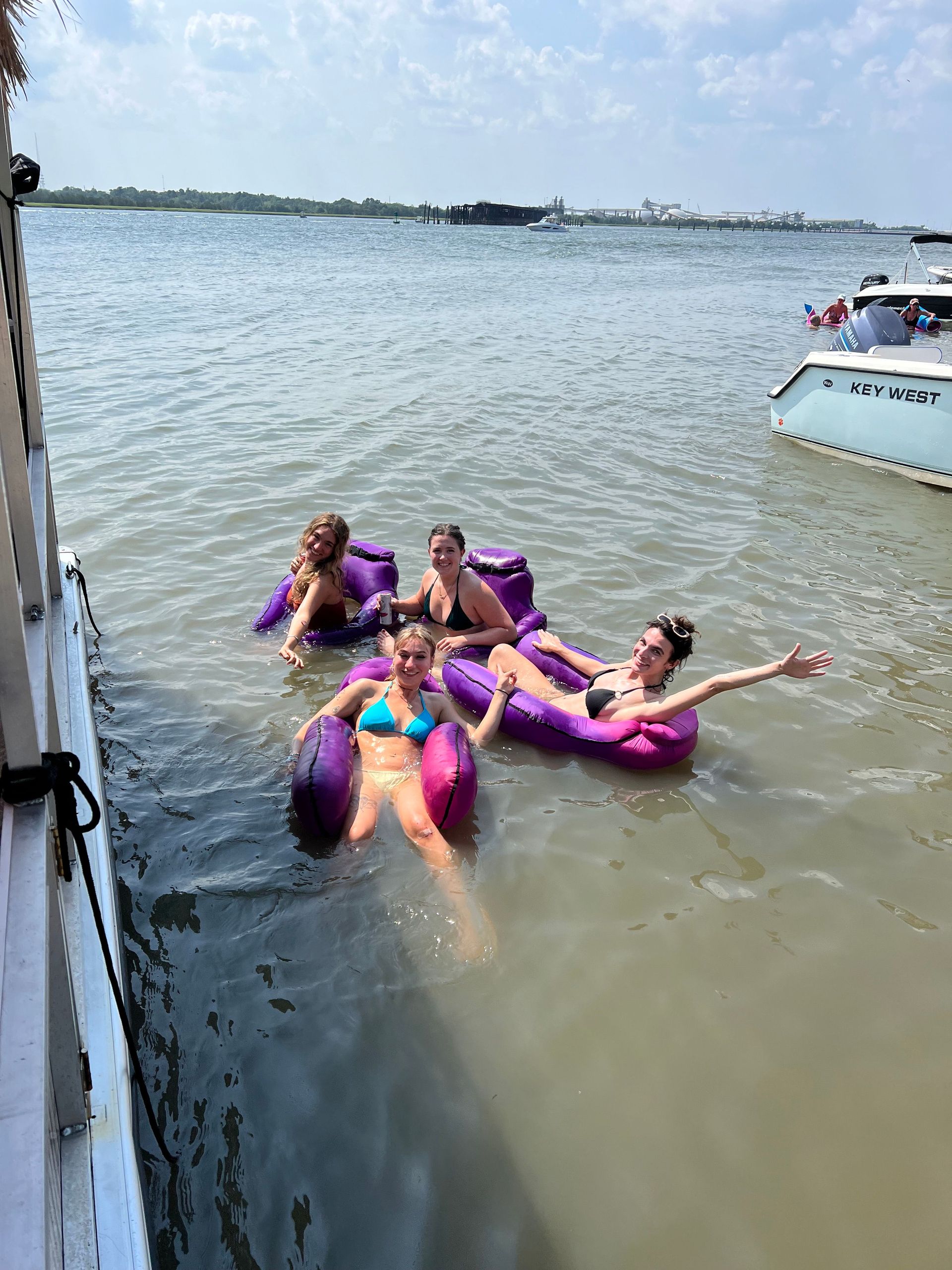 A group of women are floating on rafts in the water.