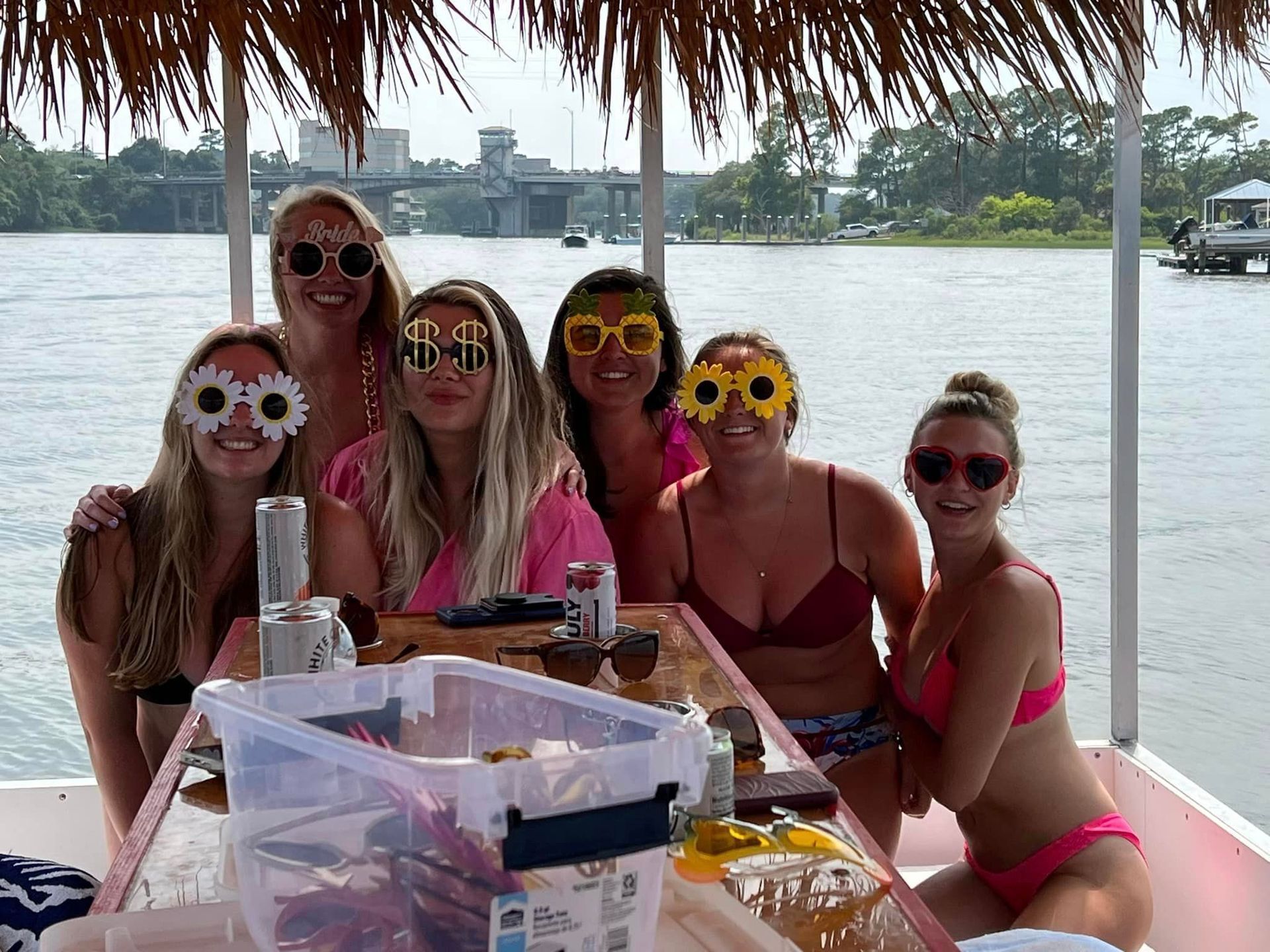 A group of women are posing for a picture on a boat.