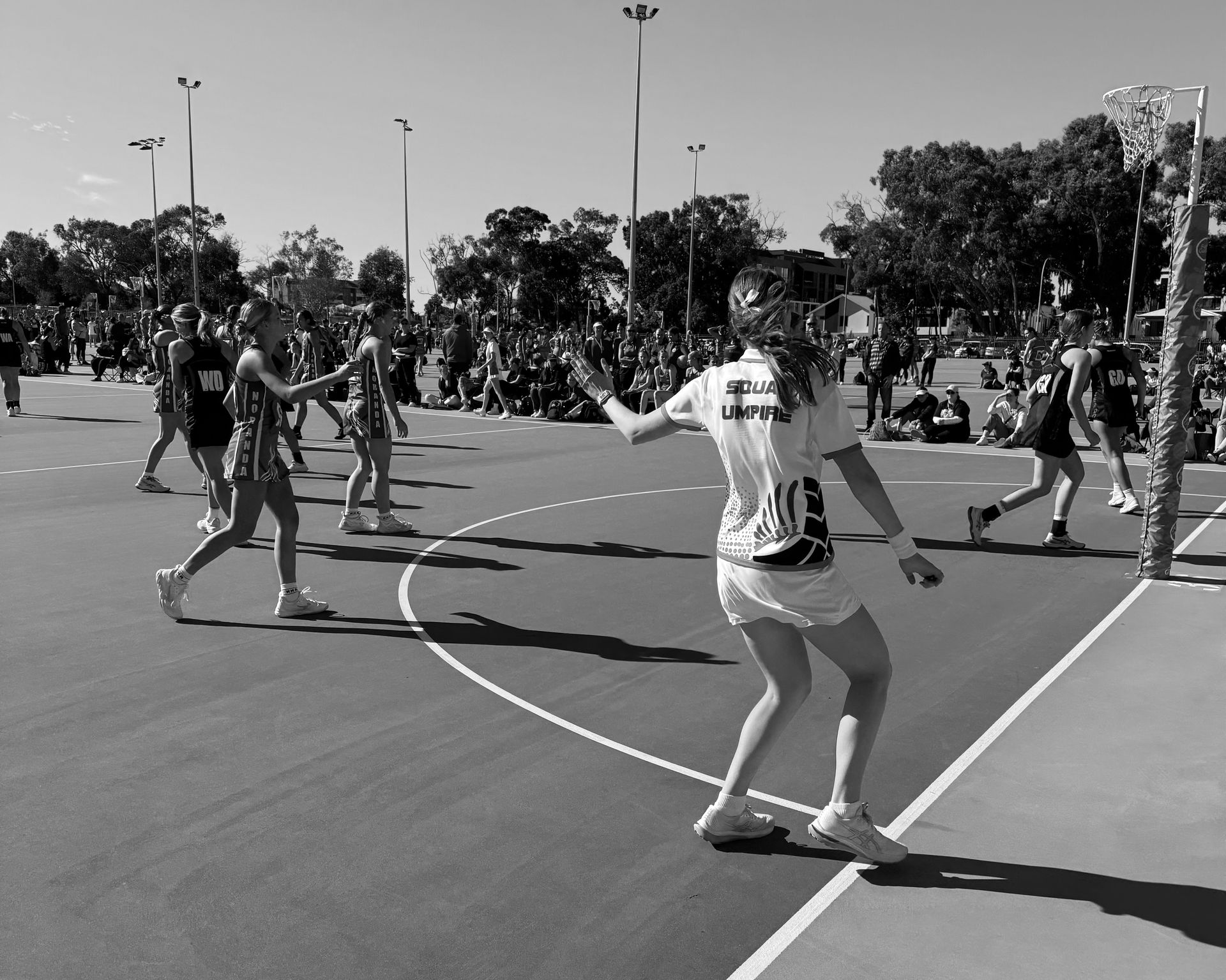 A black and white photo of a netball game