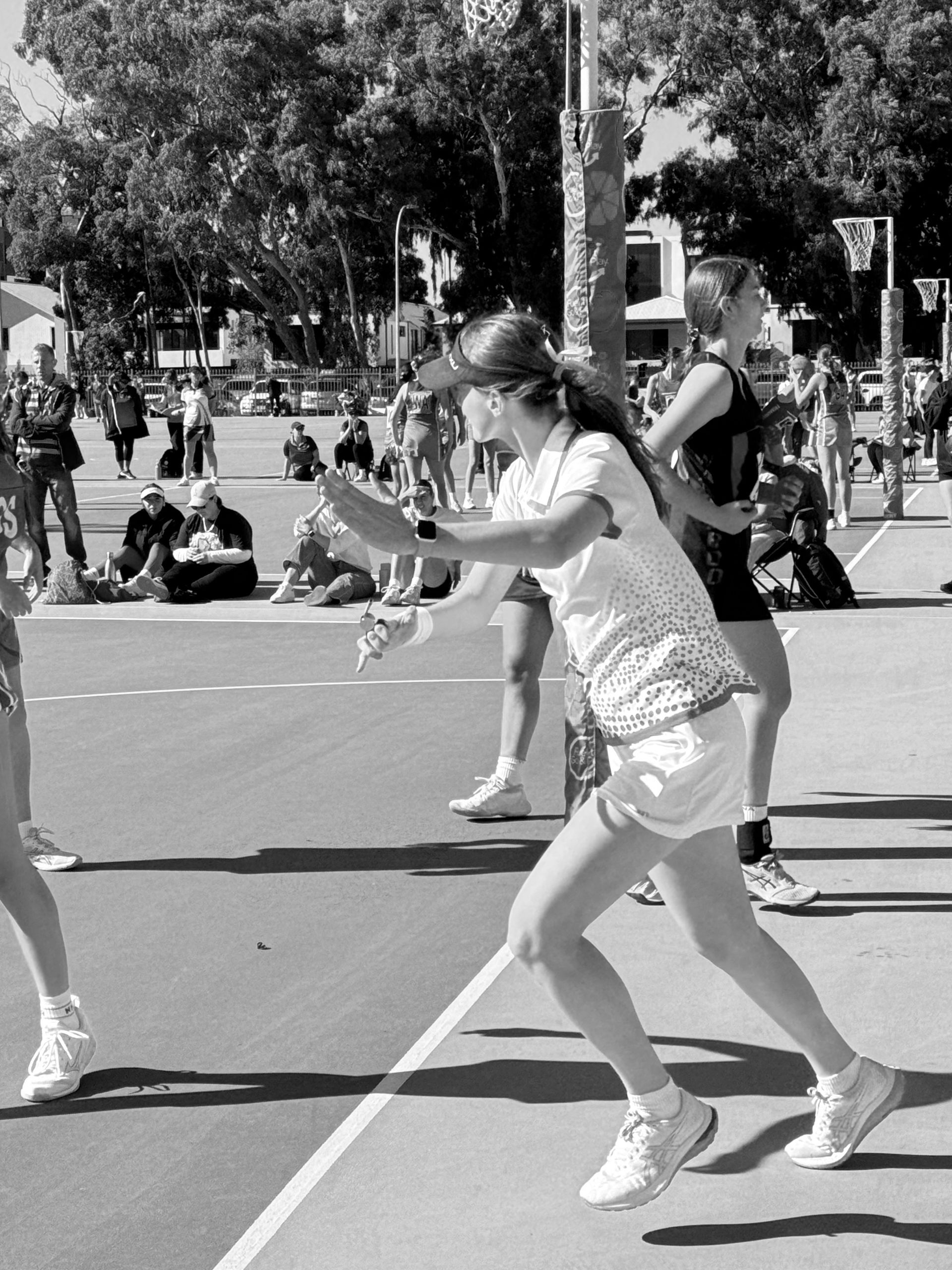 A black and white photo of people playing tennis