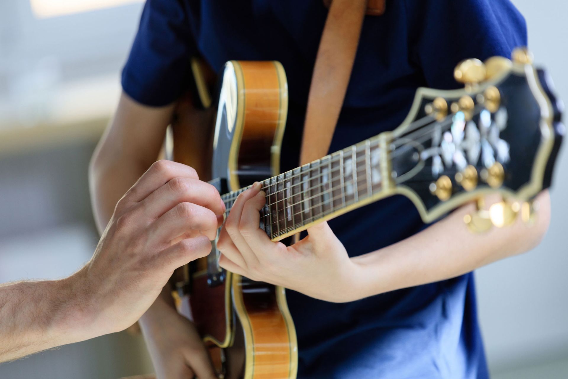 Teenage boy learning electric guitar from trainer | Penrith, NSW | Penrith School Of Guitar