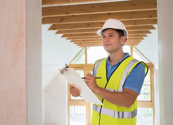 Home Inspector — Building Inspector Looking at New Property in Orange County, CA