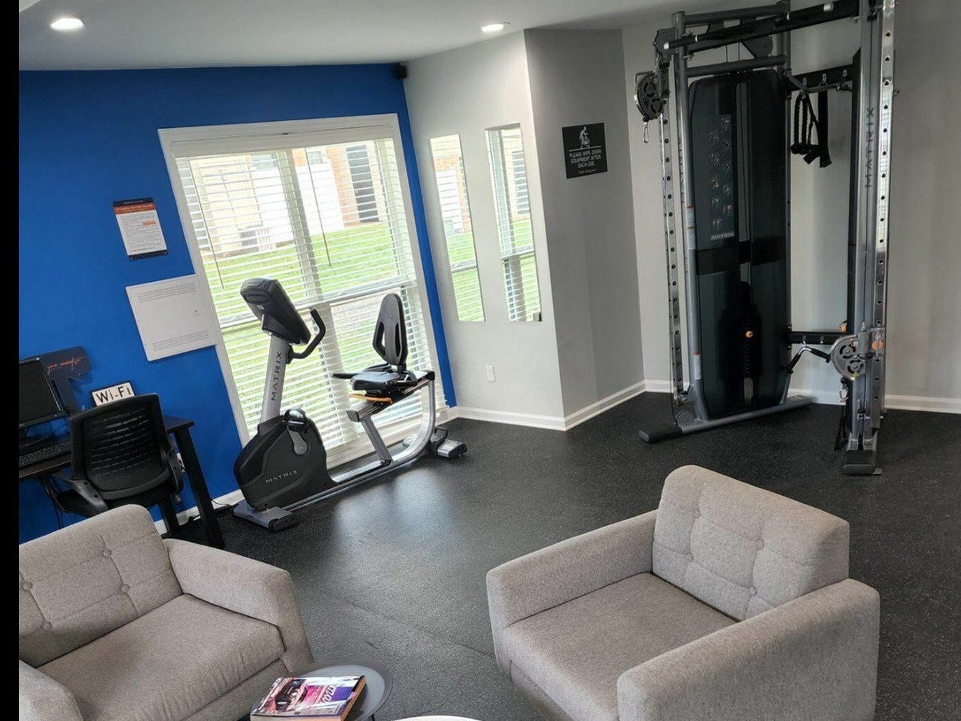 On-site fitness center with a cardio bike and weight machine.