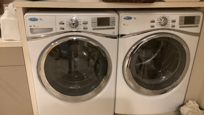 A washer and dryer are sitting next to each other in a laundry room.
