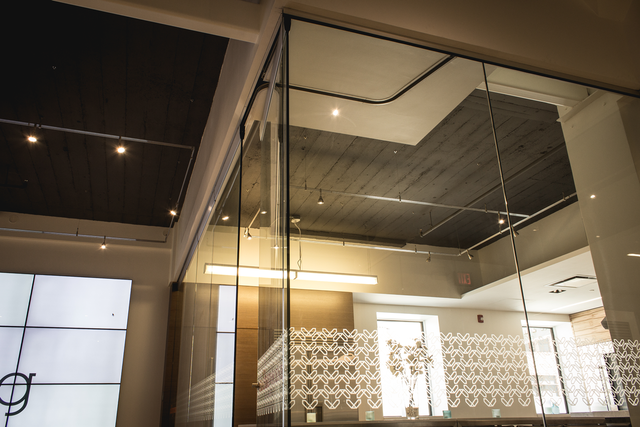 A room with a lot of glass walls and a ceiling