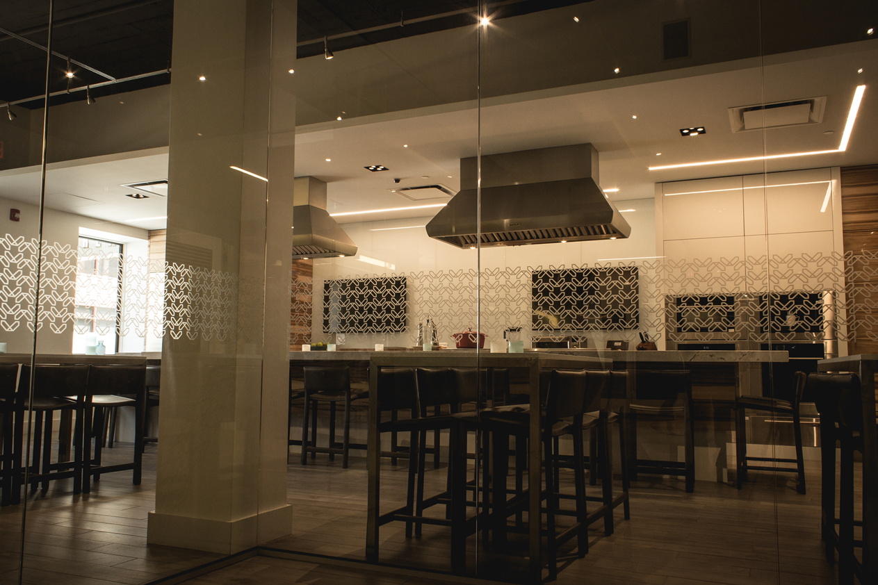 A large room with a lot of tables and chairs in it.