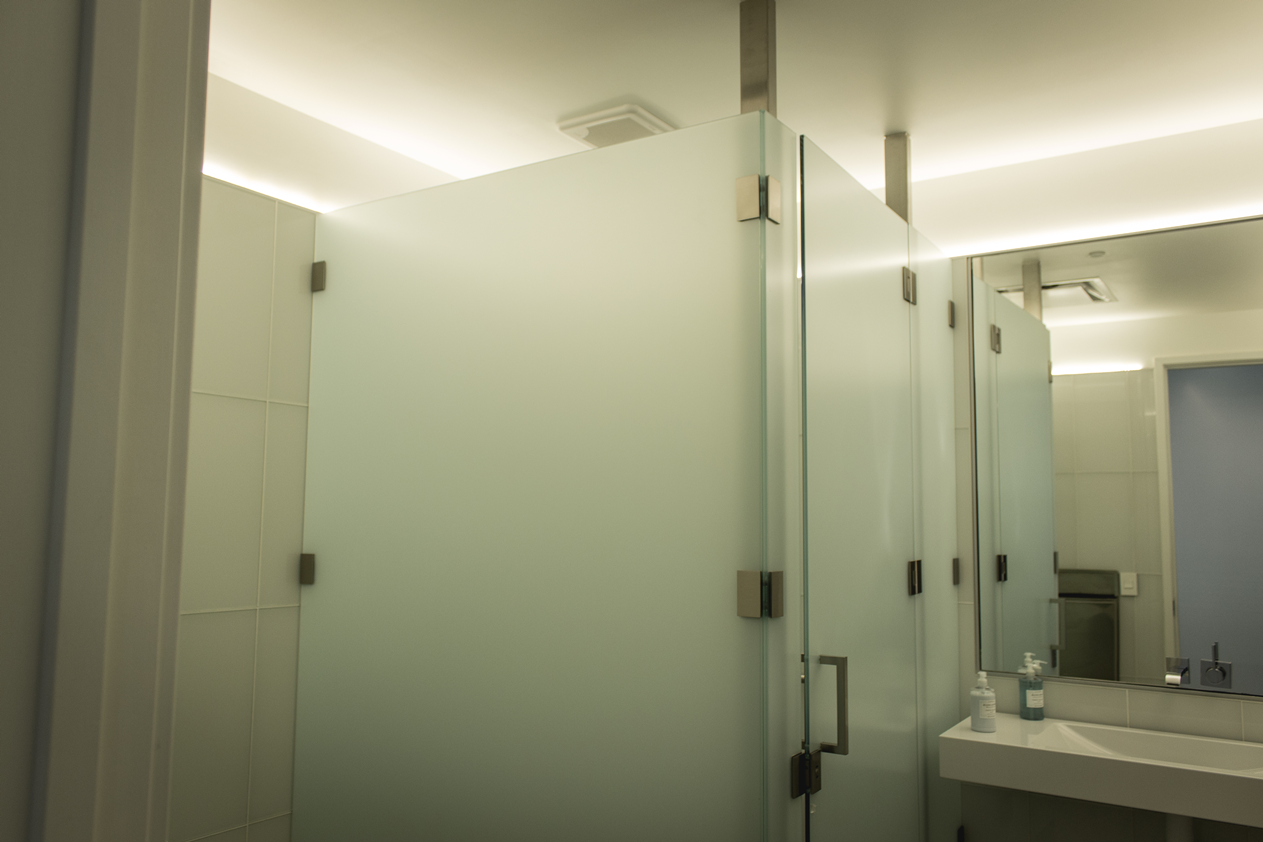 A bathroom with a shower stall and a sink.