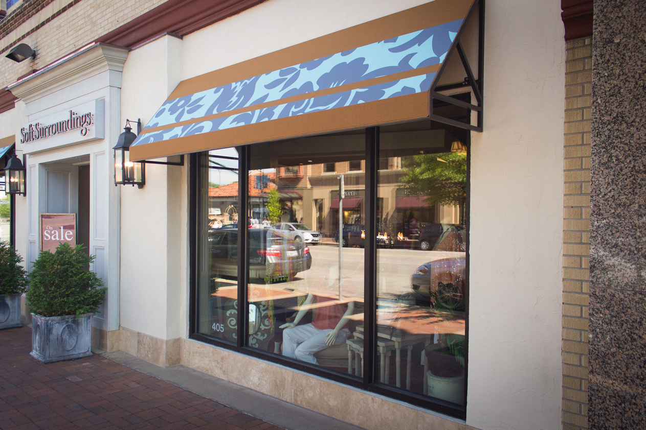 A restaurant with a blue awning on the window.