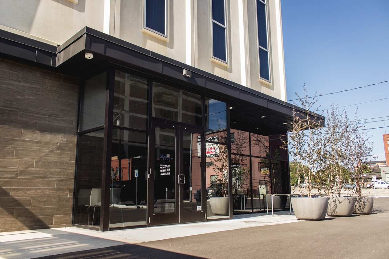 A building with a lot of windows and planters in front of it